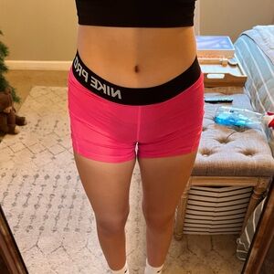 Hot pink nike pros that are excellent for sports practices.